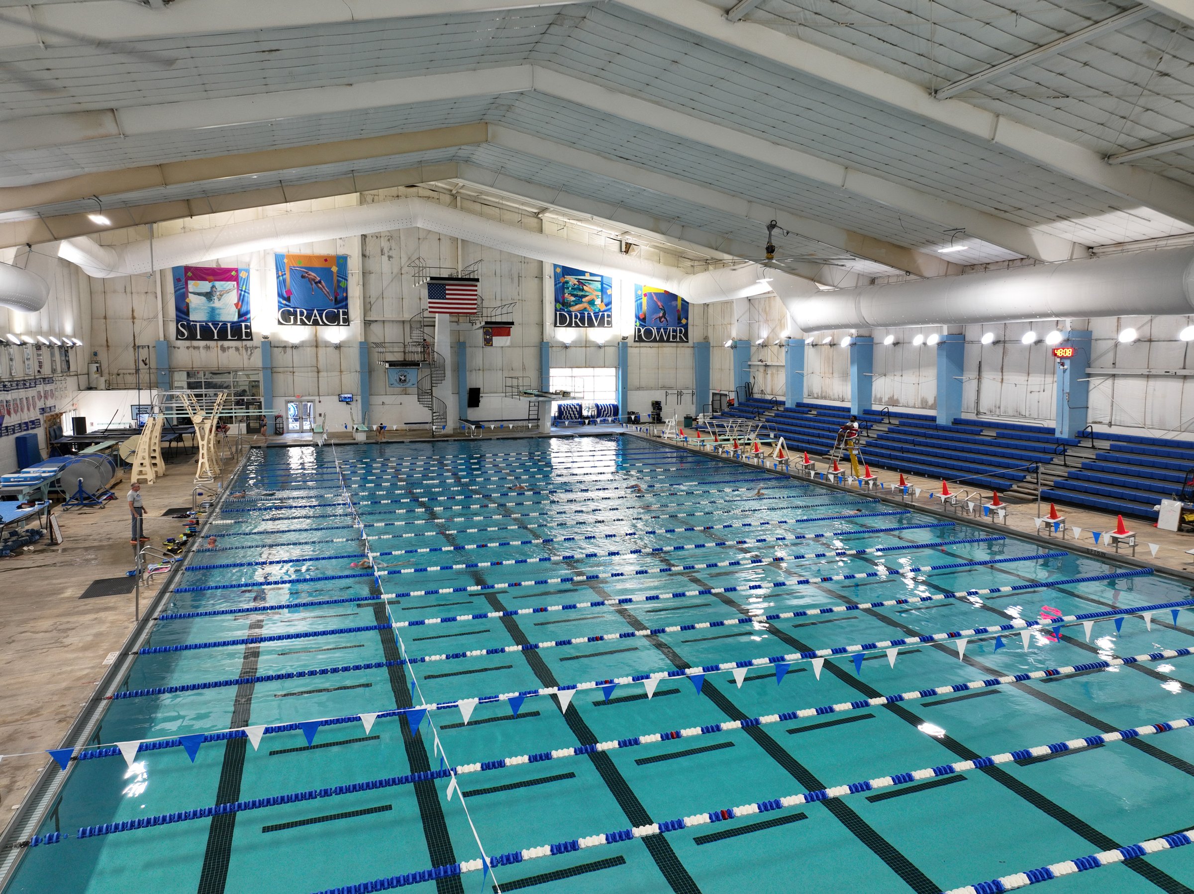 Indoor lap pool with lane lines and spectator seating
