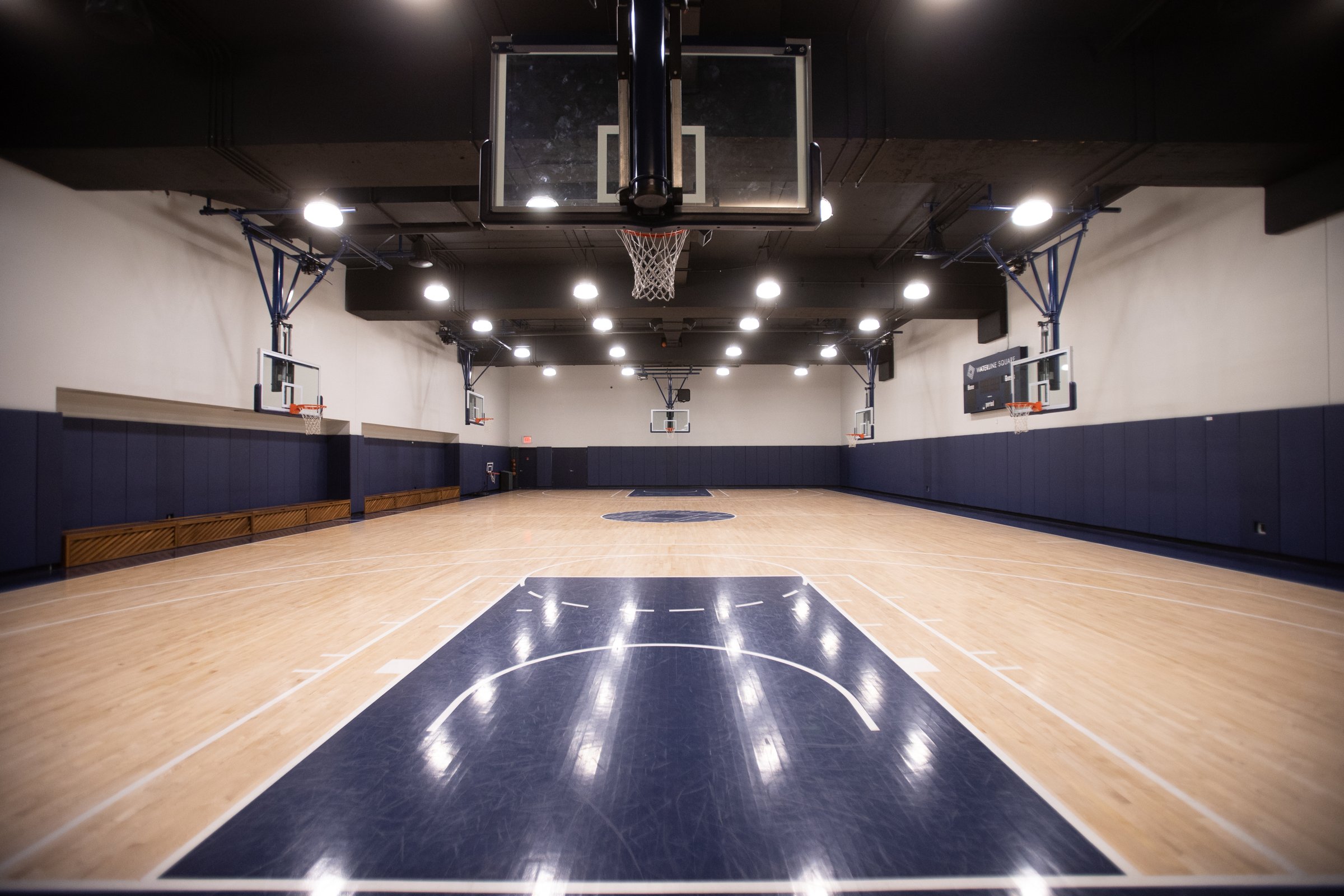 Indoor basketball gymnasium with center court logo