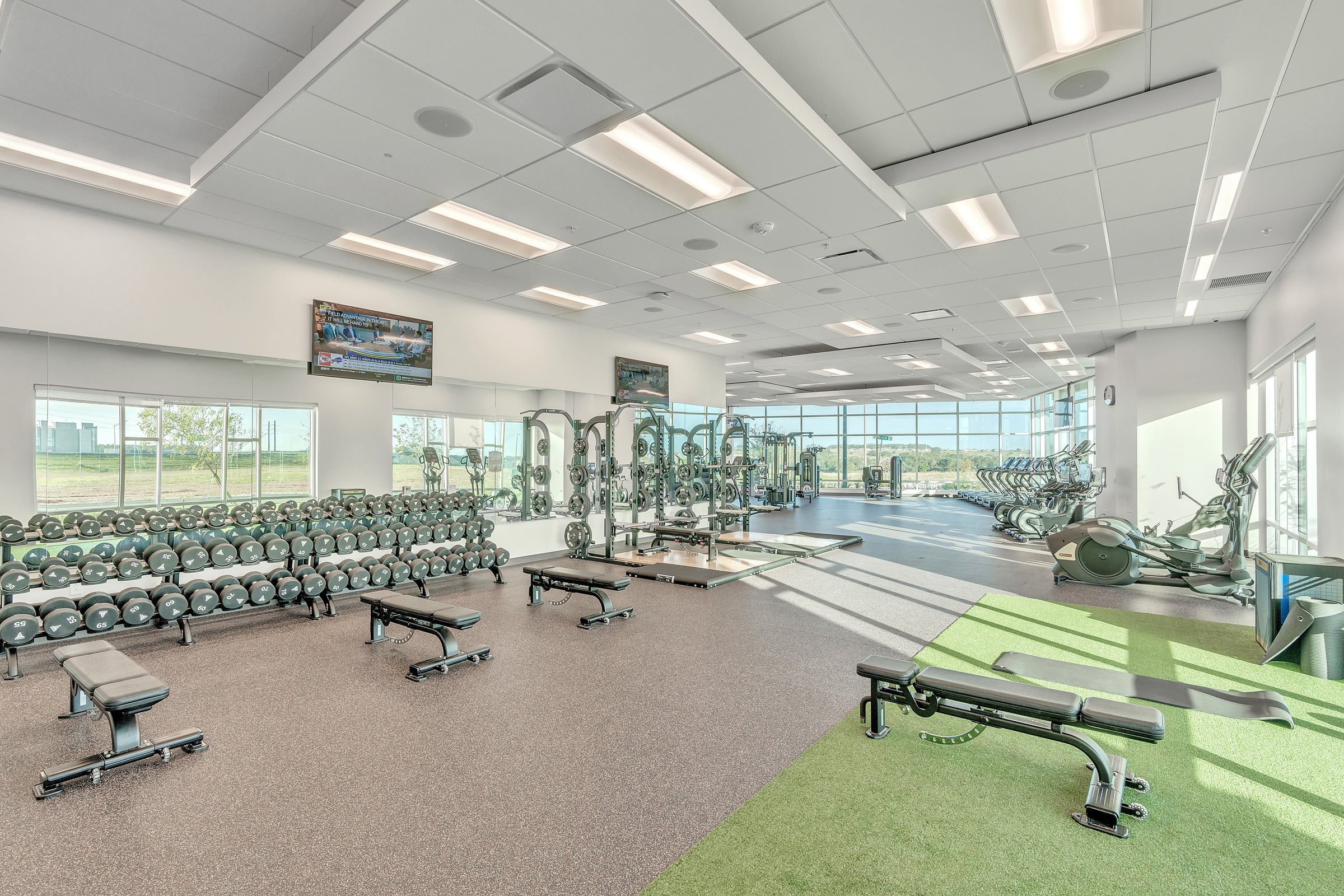 Student apartment fitness center with cardio machines and free weights