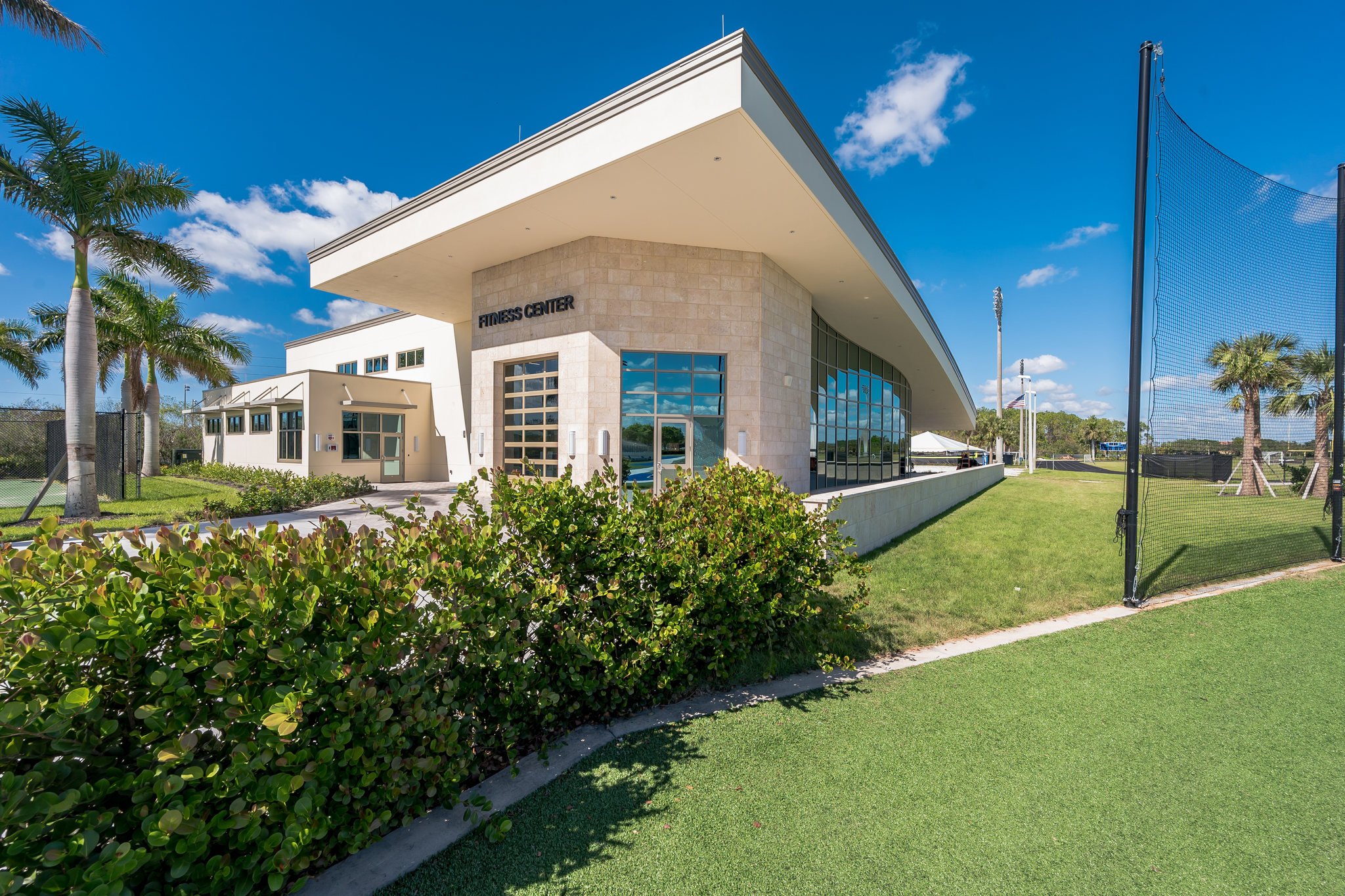 Modern single-story fitness building with landscaped entrance