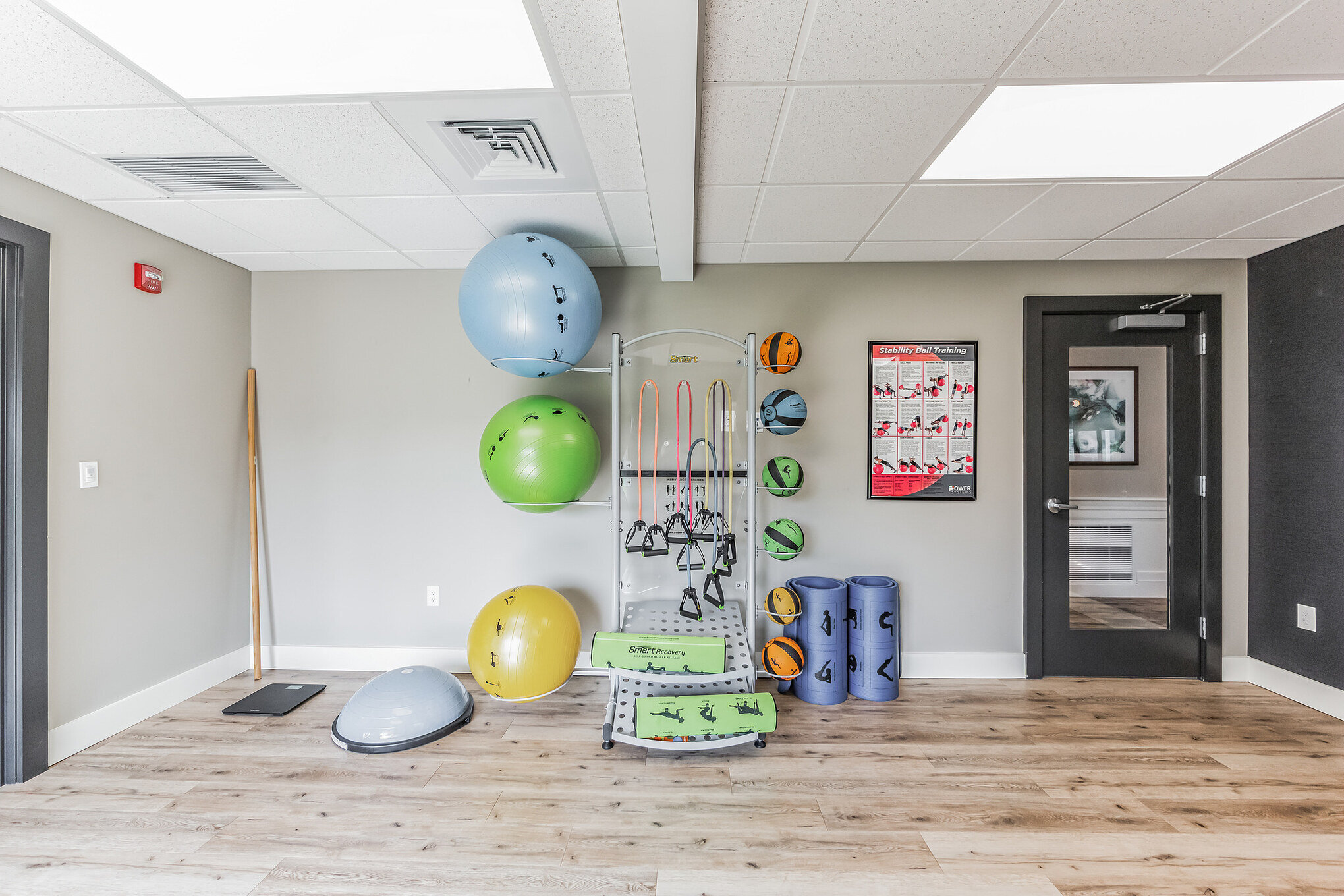 Compact studio room with stability balls, resistance bands and floor mats