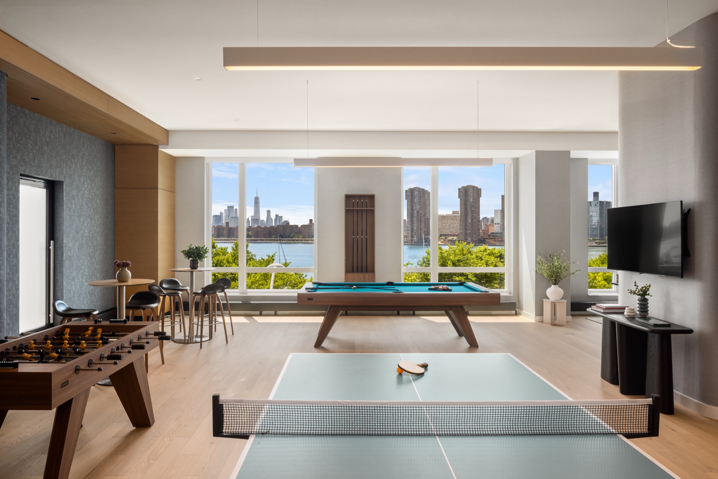 Game lounge with pool table, foosball and ping pong overlooking the skyline