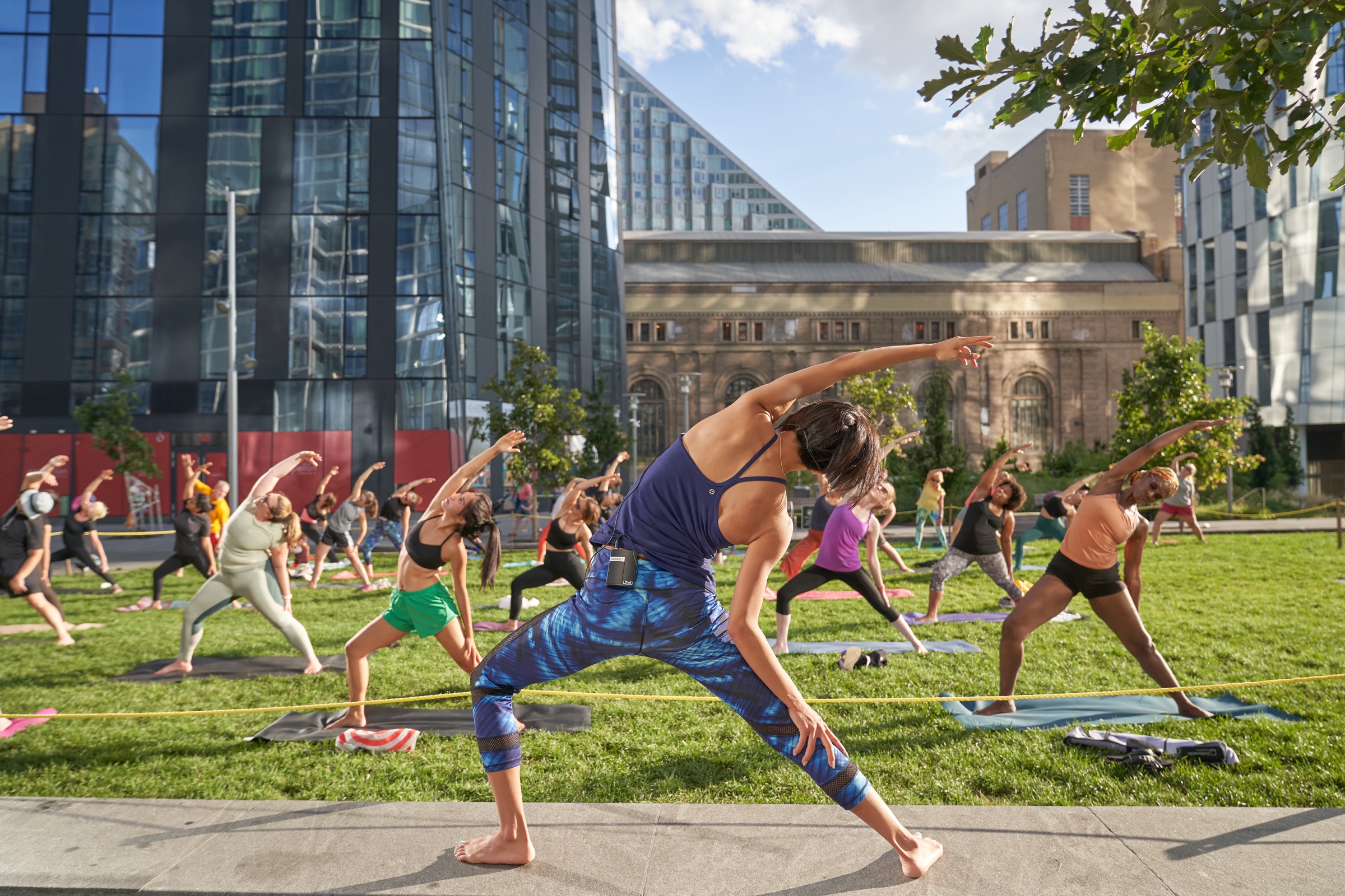 Outdoor yoga class on a waterfront lawn