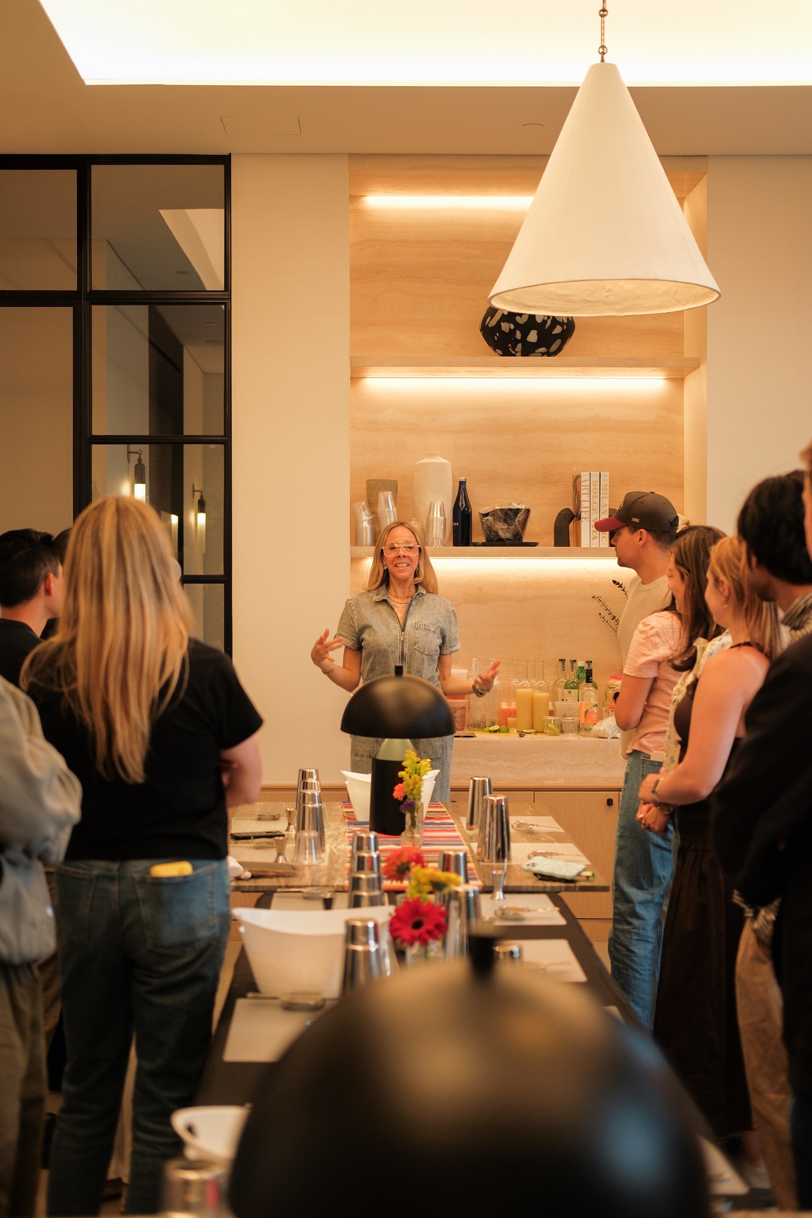 Residents gathered at a warmly lit kitchen and bar